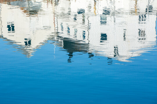 An abstract and shimmering reflection of white building on water surface in Lofoten Islands, Northern Norway
