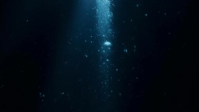 深海の闇に差し込む一筋の青白い光・神秘的な水中映像