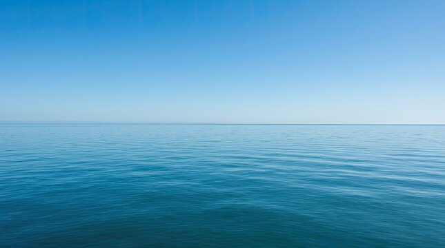 Calm ocean water with clear blue sky.