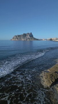 Drone flying low over rocky coastline of calpe