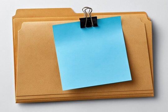 Manila folder with blue sticky note clipped on front surface
