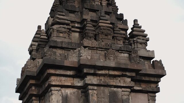 Cinematic footage of the historic Prambanan Temple in Indonesia. Majestic stone structures, intricate carvings, and ancient architecture create a powerful cultural and spiritual atmospher