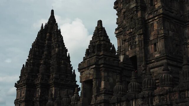 Cinematic footage of the historic Prambanan Temple in Indonesia. Majestic stone structures, intricate carvings, and ancient architecture create a powerful cultural and spiritual atmospher