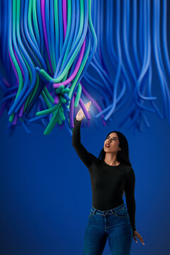 3D data cable reach woman under hanging digital line