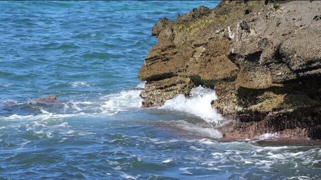 Waves on the rocky coast of Cala Blava, Mallorca, create spray and water movement. Ideal for nature, travel, or background videos with a dynamic effect. 4K UHD (3840x2160), 25fps, 33 seconds, 485 MB