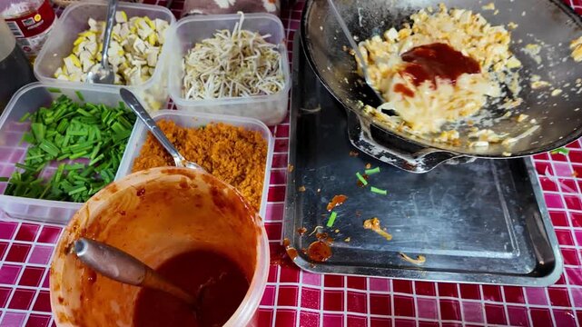 Adding Sauce to Pad Thai in Wok with Fresh Ingredients 4K Thai Street Food