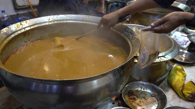 Nihari served hot from pot with ladle and street food feel, comfort food concept