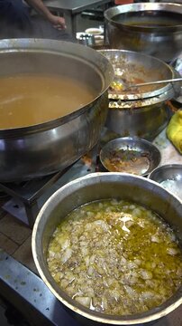 Nihari pots steaming with rich broth in authentic street setup, traditional food concept