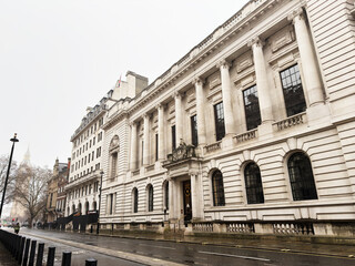 Naklejka premium Neoclassical government Institution of Civil Engineers building with grand columns on a rainy London, UK street, historic urban architecture