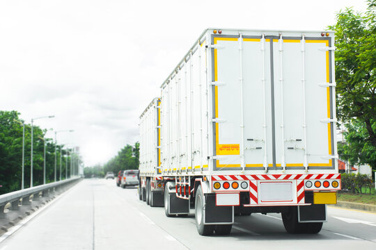 Semi-Trailer Transport Truck on Highway, A large white semi-trailer truck travels along a highway, symbolizing efficient freight distribution, cargo shipping, and supply chain.