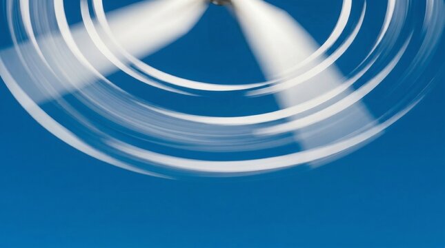 Spinning wind turbine blades in minimalist motion blur style, blue and white colors, representing renewable energy and sustainable wind power with copy space
