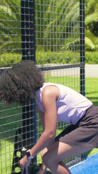 Vertical video: Shifting woman in skort, paddle grabbing bottle drinking on court man touching nape