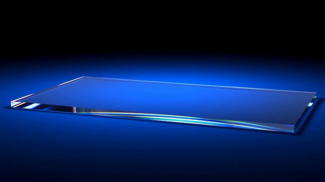 Tracking shot with slight dolly of glass panel tilting and rotating while sliding across illuminated blue studio surface with reflective prism edges and gradient backdrop