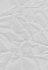 Fototapeta premium Textured Paper's Whispers: Close-up of crumpled paper, revealing an intricate tapestry of folds and shadows, ideal for conveying depth, texture, and abstract design.