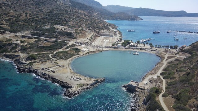 Aerial drone view of Knidos Ancient City in Dat&ccedil;a, surrounded by deep blue and turquoise shades of the Aegean Sea, ancient ruins on a dramatic peninsula, crystal-clear water, cinematic wide angle, ser