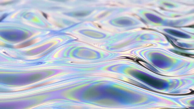 Slow tracking shot of iridescent liquid surface rippling and shifting with shimmering metallic waves on reflective tabletop in studio close up macro