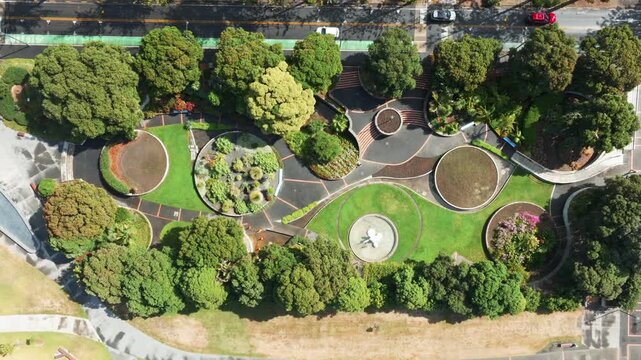 Ariel view of the lush green landscape and modern architecture of the Marine Parade, Napier, Hawkes Bay, New Zealand, showcasing its vibrant urban park.