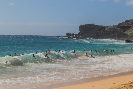 People body surfing in waves on Sandy Beach, Oahu, Hawaii