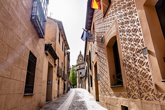 The city center of the fortified city of Segovia that is located in central Spain.  The city has a large aqueduct near the city center.