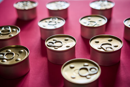 Metal tin cans on pink background