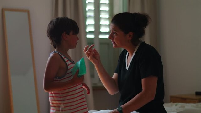 Mother scolds child for misbehavior then checks head injury and embraces him showing emotional parenting cycle discipline care concern and reassurance in authentic family scene