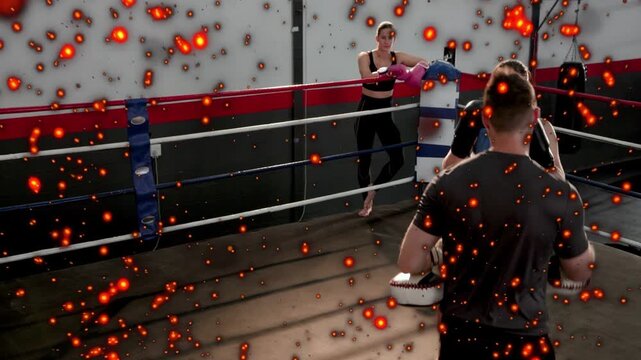 Trainer calling targets female boxer moving striking mitts jab cross for sports specks dimming view