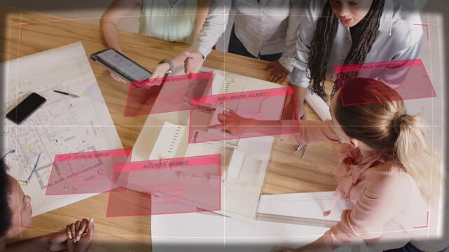 Architects pointing at scale model, using tablet, showing expanding red tags over plans, reviewing