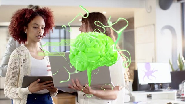 Three women gesturing at laptop and tablet, creating neon-green AR brain while working on tech demo