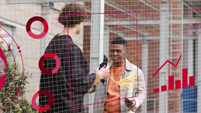 Taller man offering folio and yellow tag for review to man with smartphone tech charts overlaying