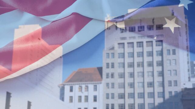 On loop start sheer flag overlaying building, rippling right, blending patriotic motif with skyline