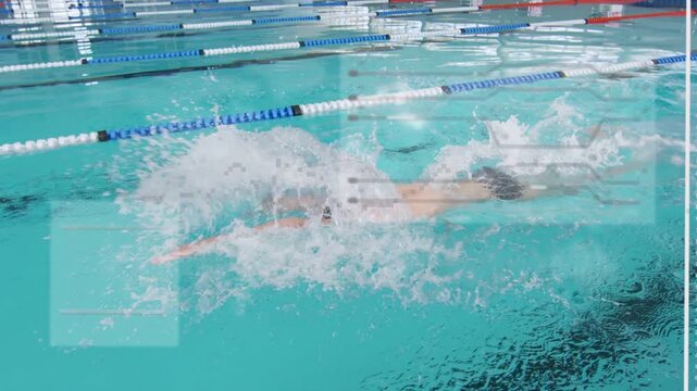Vertical video: Lifting head to inhale, swimmer with cap breaststroking across lane ropes, training