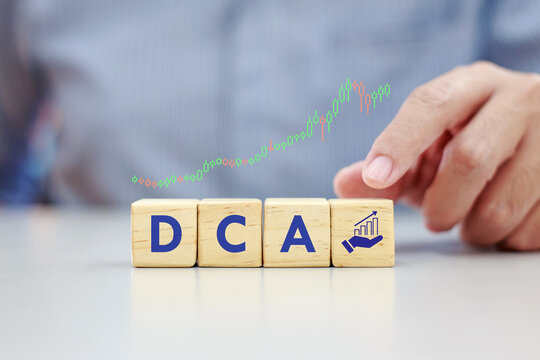 Financial investment concept of Dollar Cost Averaging (DCA) and Mutual Funds with savings on wooden blocks.