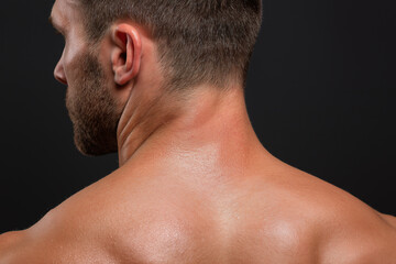 Naklejka premium Healthy male upper back with mild acne and skin serum gliding over blemishes, close up of textured skin, pores and shoulders showing skincare treatment and masculine grooming