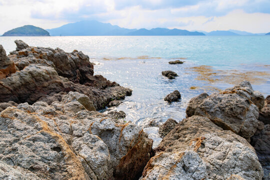 Distant mountain view over the rocky shores and shallow waters of islands in Daya Bay, Huizhou, Chin