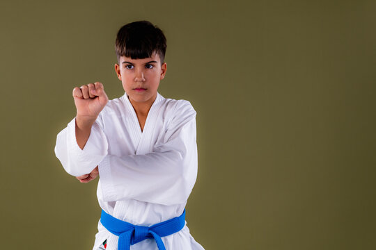 Young karate student performs uchi uke with correct chamber hand placement, emphasizing form and coordination.