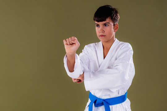oung martial artist demonstrates a punch with correct chamber position and stable stance, showing control and balance.