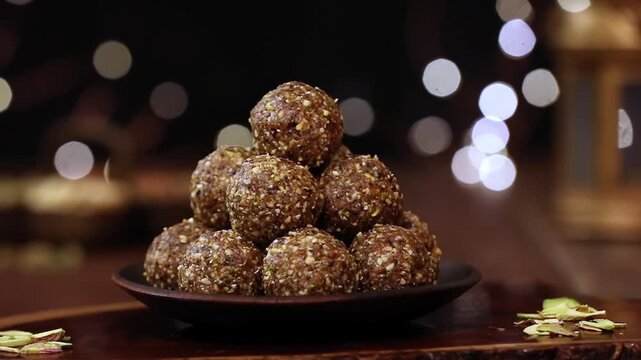 Dry Fruit Energy Balls stacked on plate in closeup show a healthy snack made with nuts and seeds. Perfect energy, snack and protein visuals with natural texture and clean presentation.