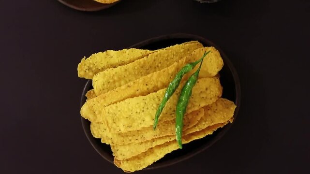 Fafda Jalebi served crispy with green chili on plate in closeup. Perfect fafda, jalebi and snack visuals with sweet and savory contrast and authentic presentation.