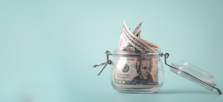 Saving money concept with cash in glass jar, represent financial planning, personal finance, budgeting, investment growth, wealth management, and secure savings strategy for future financial stability