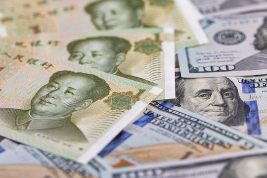 Macro shot of Chinese Yuan and US Dollar banknotes together