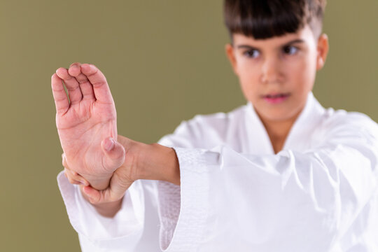 Karate students hand posture during a defensive move. Highlights correct form, concentration, and technical execution.