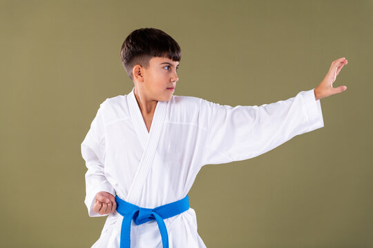 Child demonstrates a basic karate blocking technique with correct hand positioning and controlled movement.