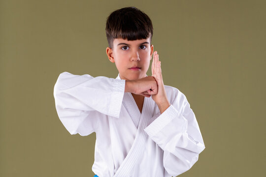 Close up front view of a karate student performing a defensive block, highlighting correct form and concentration.