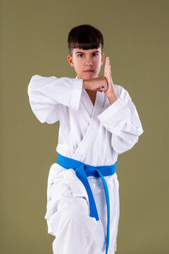 Demonstrating a middle block, chudan uke, with proper hand positioning and strong stance in a front facing pose.