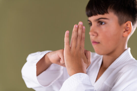 Close up of a young karate student performing a Shotokan hand guard position , kamae, showing correct form, focus, and controlled technique execution during training.