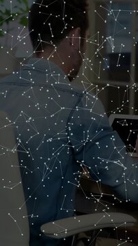 Vertical video: Man tapping tablet, swiping, showing constellation, viewing tech, turning smiling