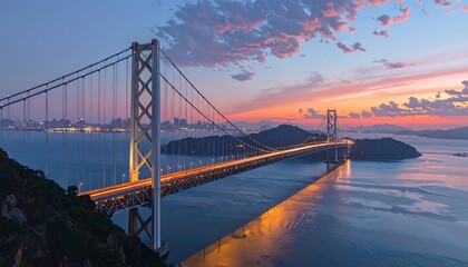 Fototapeta premium A suspension bridge spans a body of water at sunset