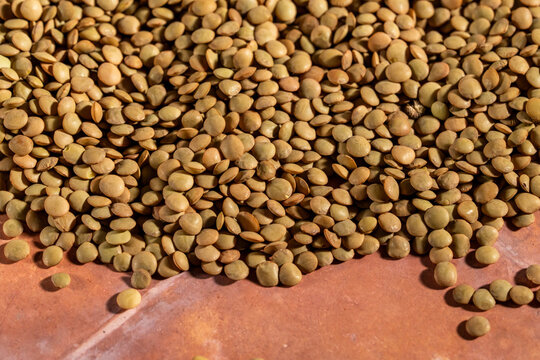Close up of lentils on a tile surface 