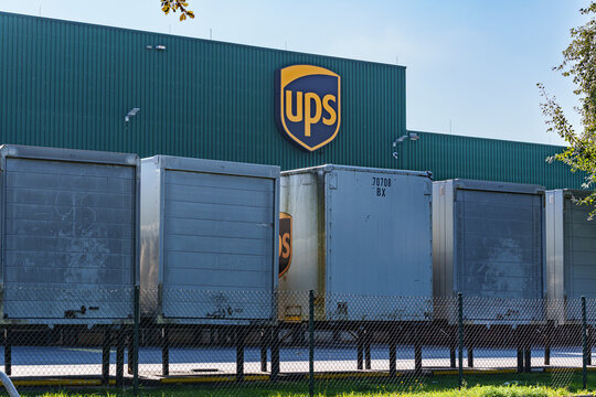Dusseldorf, Germany - September 28 2025: UPS logistics warehouse with trucks and containers parked at loading area
