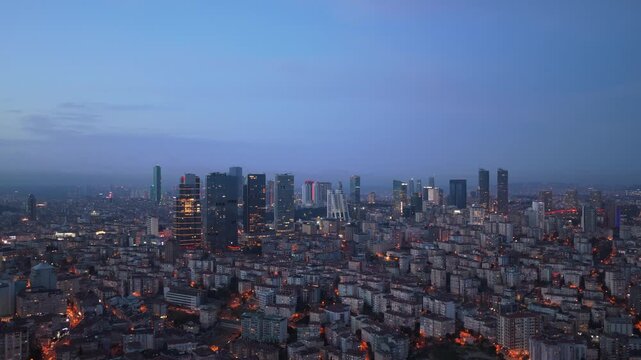 Twilight descending over Istanbul with modern Levent financial district skyline and urban sprawl of sprawling metropolis illuminated by city lights in Turkey